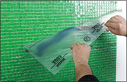 Removing clear adhesive face-mount film from mosaic tiles