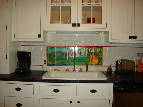 Residential Kitchen Backsplash in Lyric Decades Vanilla Bevelled Subway Tile with custom Sublimation tile design.