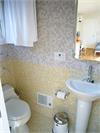 Light Yellow and Gray Variegated Hexagon Tile Bathroom Walls